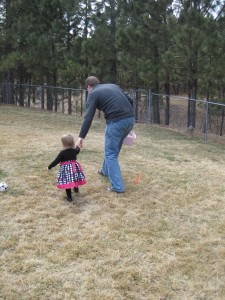Uncle Jeff helping Kamea find eggs